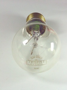 Marca "TXIMIST" sobre la ampolla, junto con indicación de la tensión y potencia.
